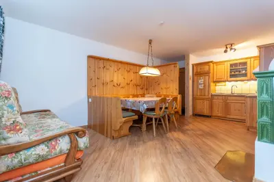a kitchen and dining room with a table and chairs at Casa Cielo Azzurro in Moena
