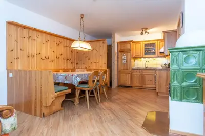 a kitchen and dining room with a table and chairs at Casa Cielo Azzurro in Moena