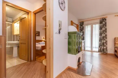 a living room with a clock on the wall at Casa Cielo Azzurro in Moena