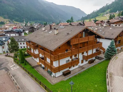 an aerial view of a large house in a village at Casa Cielo Azzurro in Moena