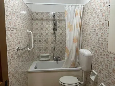 a bathroom with a tub and a toilet and a shower at Mansarda Mulaz in Falcade
