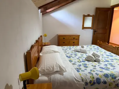 a bedroom with a bed with towels on it at Mansarda Mulaz in Falcade