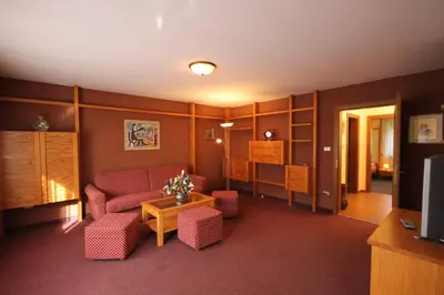 a living room with a couch and chairs and a tv at Residence Ben Ste in Ortisei