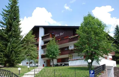 a building with trees in front of it at Residence Ben Ste in Ortisei