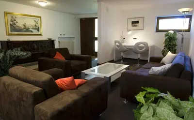 a living room with two couches and a table at Residence Ben Ste in Ortisei