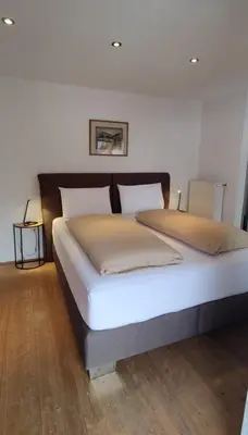 a bed with two pillows on it in a bedroom at Alp-Hof Apartments in Stanghe