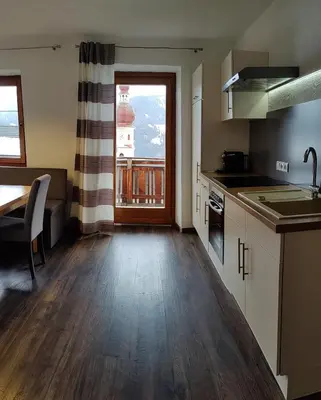 a kitchen with a sink and a counter top at Alp-Hof Apartments in Stanghe