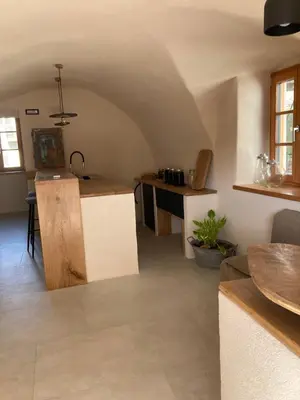 a kitchen with a table and a counter in a room at Agriturismo Mirtilla in Trento
