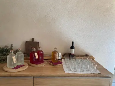a table with wine bottles and glasses on it at Agriturismo Mirtilla in Trento