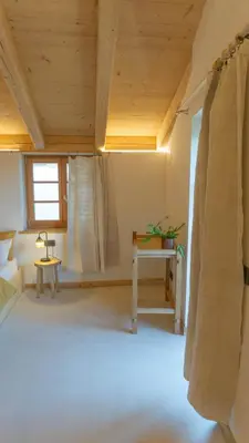 a living room with a wooden ceiling and a table at Agriturismo Mirtilla in Trento