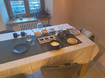 a table with plates and bowls on top of it at Agriturismo Mirtilla in Trento