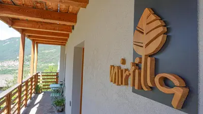a wooden sign on the side of a house at Agriturismo Mirtilla in Trento
