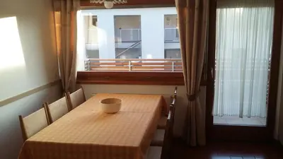 a table with a cup on it in front of a window at Alping Apartments in Brunico