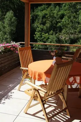 a table and two chairs sitting on a porch at Haus Valier Tiers in Tires