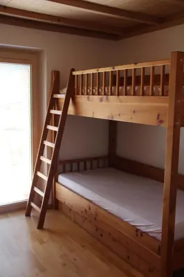 a bedroom with two bunk beds and a ladder at Haus Valier Tiers in Tires