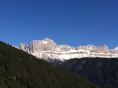 a snow covered mountain with trees in front of it at Haus Valier Tiers in Tires