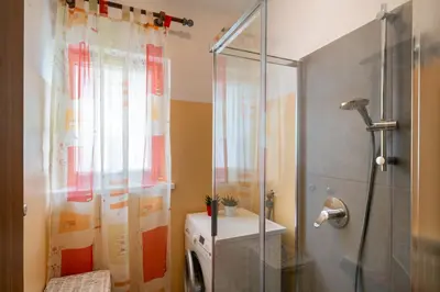 a bathroom with a shower with a shower curtain at Casa Rosina in Tesero