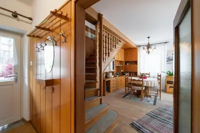 a kitchen and dining room with a staircase in a house at Casa Rosina in Tesero