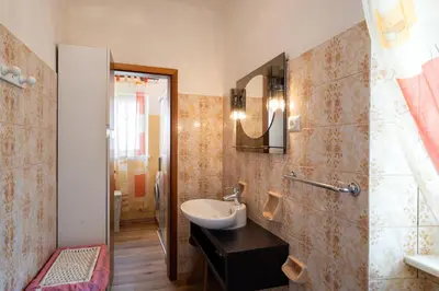 a bathroom with a sink and a mirror at Casa Rosina in Tesero