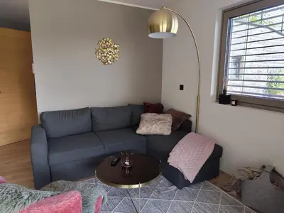 a living room with a couch and a table at Janas Bolzano Mountain Apartment in Tesimo