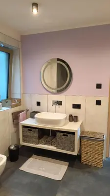 a bathroom with a sink and a large mirror at Janas Bolzano Mountain Apartment in Tesimo