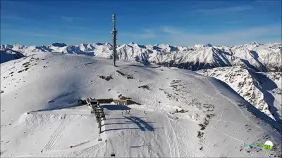 a snow covered mountain with a pole on top of it at Janas Bolzano Mountain Apartment in Tesimo