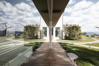 a white house with a view of a yard at Served Apartements Belvedere in San Genesio Atesino