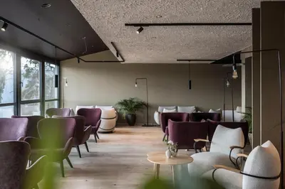 a waiting room with chairs and a table at Served Apartements Belvedere in San Genesio Atesino
