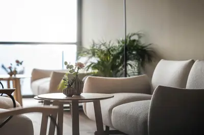 a living room with couches and a table with a vase on it at Served Apartements Belvedere in San Genesio Atesino