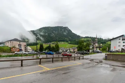 a parking lot in a town with a mountain at Casa Nuccia in Moena