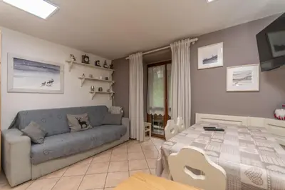 a living room with a couch and a table at Casa Nuccia in Moena
