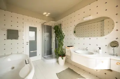 a bathroom with a tub and a sink and a mirror at 240qm Luxus Apartment - Natur & Wandern zw Bozen und Meran in Nalles