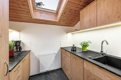 a kitchen with wooden cabinets and a sink at Punterhof in Varna