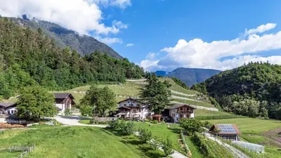 a village in the mountains with houses and trees at Punterhof in Varna