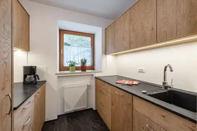 a kitchen with wooden cabinets and a sink at Punterhof in Varna