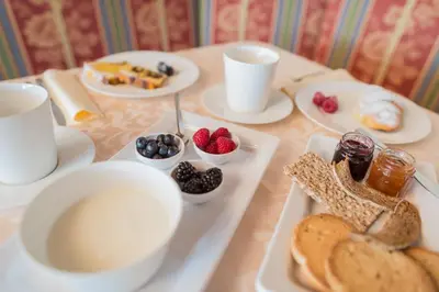 a table topped with plates of food and desserts at Hotel Garni Hochgruber in Brunico