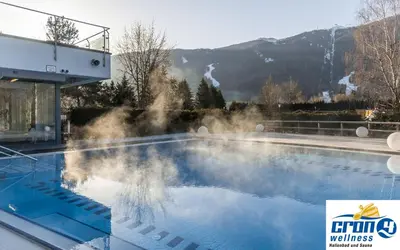 a swimming pool with steam coming out of it at Hotel Garni Hochgruber in Brunico