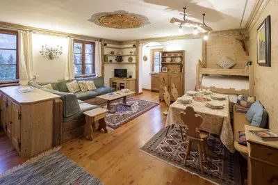 a living room with a couch and a table at Villa Marianna - Stayincortina in Cortina dʼAmpezzo