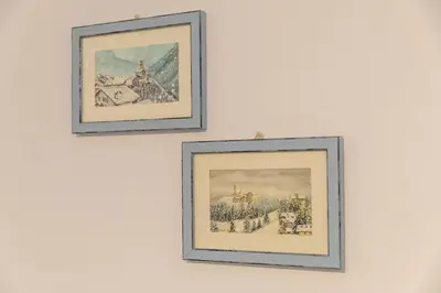 three framed pictures hanging on a white wall at Cesa dele Angele in Colle Santa Lucia
