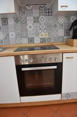 a kitchen with a stove top oven in a kitchen at Appartamento Aquila D'oro in Vipiteno
