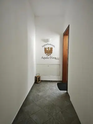 an empty hallway with a sign on the wall at Appartamento Aquila D'oro in Vipiteno