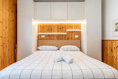 a bedroom with a large white bed with two pillows at Bilo Cornetto Bianco in Predazzo