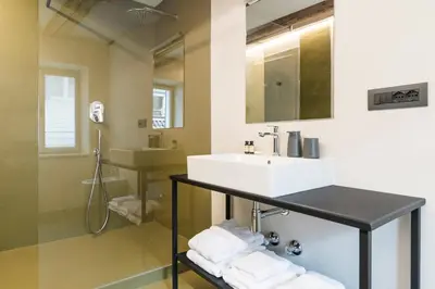 a bathroom with a sink and a mirror at Alte Schmiede Apartments & Rooms in Bolzano