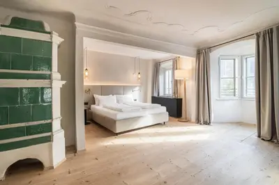 a bedroom with a bed and a fireplace at Alte Schmiede Apartments & Rooms in Bolzano