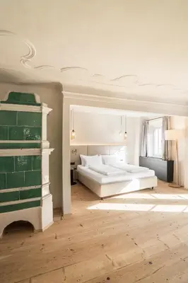 a bedroom with two beds and a fireplace at Alte Schmiede Apartments & Rooms in Bolzano