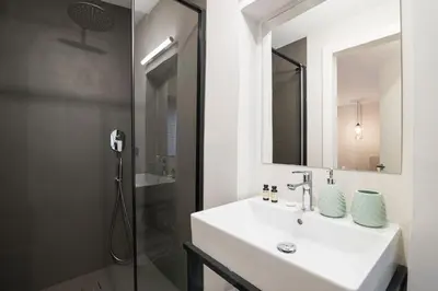 a bathroom with a sink and a shower at Alte Schmiede Apartments & Rooms in Bolzano