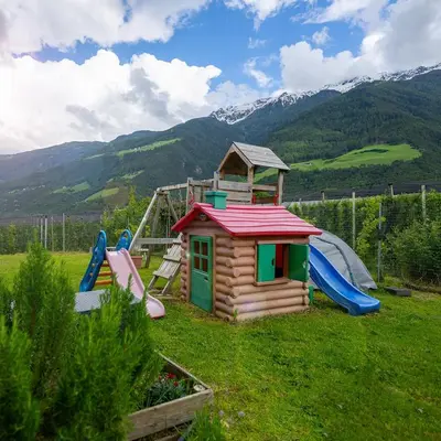 a small playground with a slide and a play structure at Biohof Gala in Naturno
