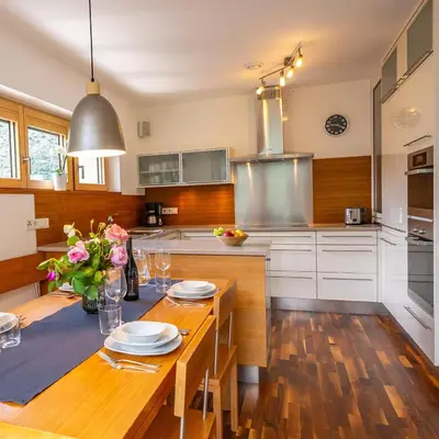 a kitchen with a wooden table with plates on it at Biohof Gala in Naturno