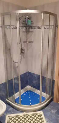 a shower in a bathroom with a blue floor at Casa Alessio in Sicina