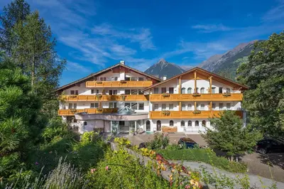 a large building on the side of a mountain at Family Hotel Gutenberg in Schenna